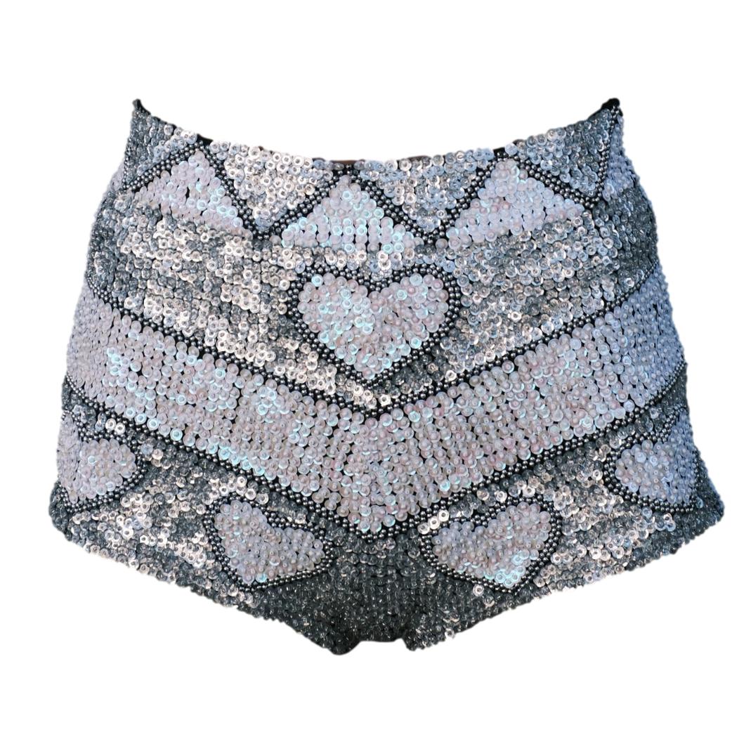 Handmade white and silver sequin high waist festival shorts with love heart design. Perfect for bridal theme hens party outfits, disco hen party, Henchella, and festival theme bachelorette parties. Stylish, sparkly hens hot pants for standout fashion.