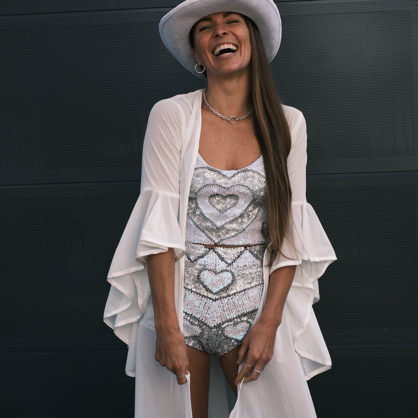 Handmade sequin hot pants with holographic silver and pearl white love hearts, ideal for hens party outfits and bachelorette parties. Fun, flirty, and perfect for any bridal or festival event.
