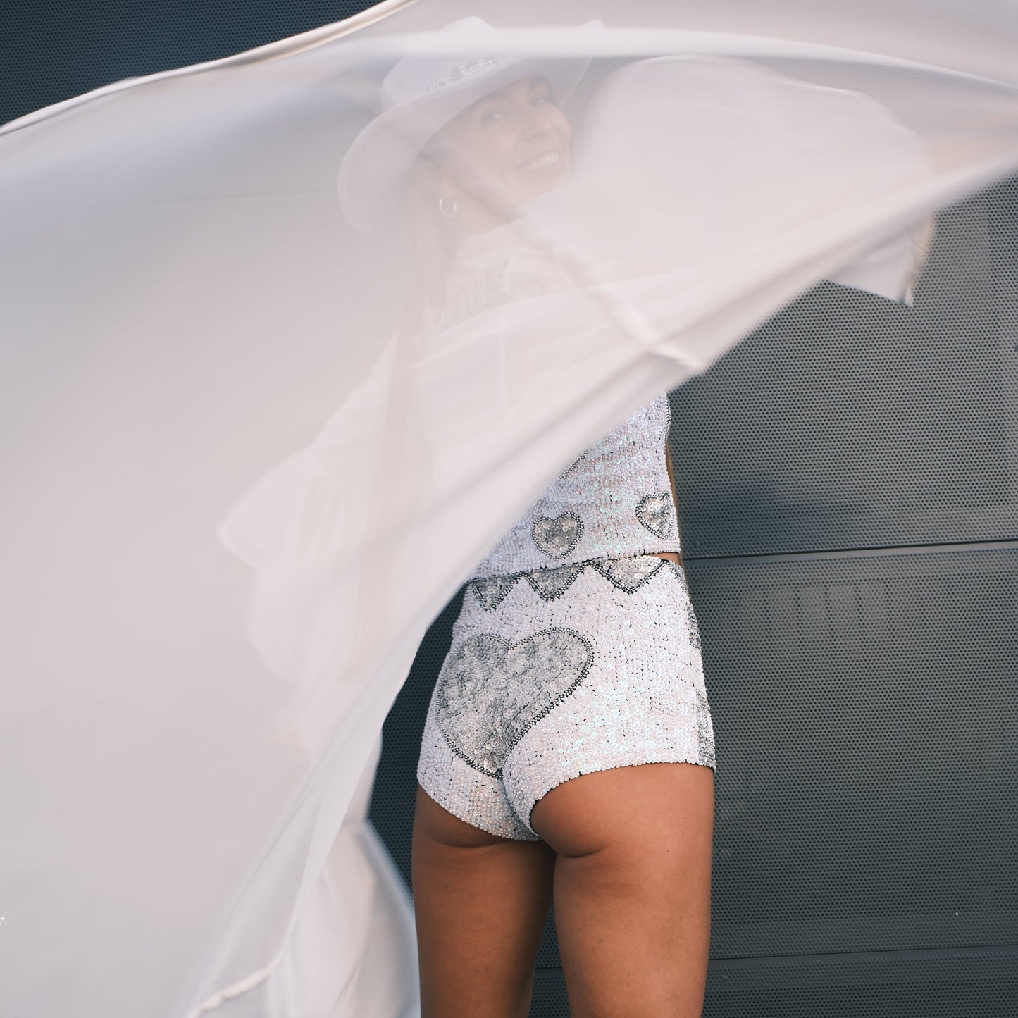 Chic handmade hot pants with love hearts in holographic silver and pearl white sequins. Ideal for bachelorette parties, hens party outfits, and adding sparkle to any festival or bridal event.