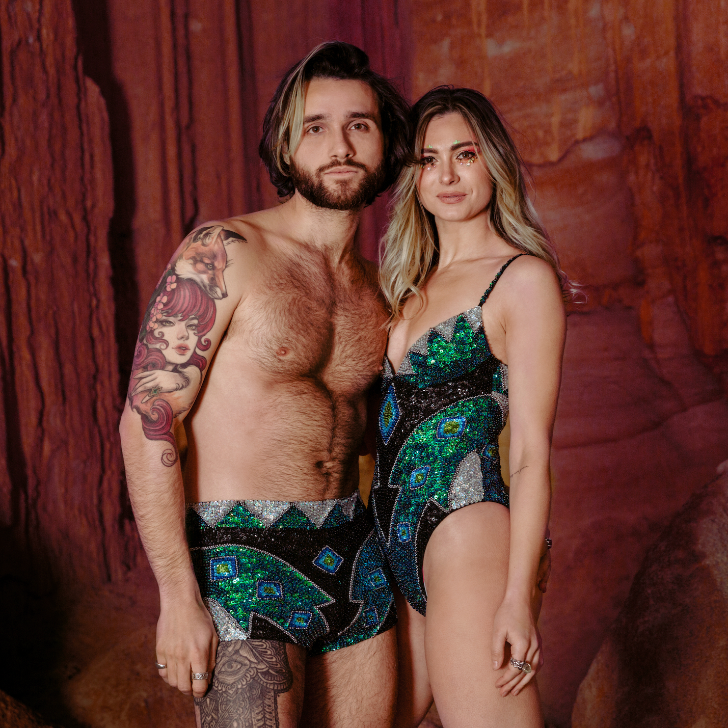 Matching festival outfit his and hers, green, black and silver sequin costumes, matching couple, model couple, festival outfits, sparkle wear, beach location shoot, caves, festival makeup.
