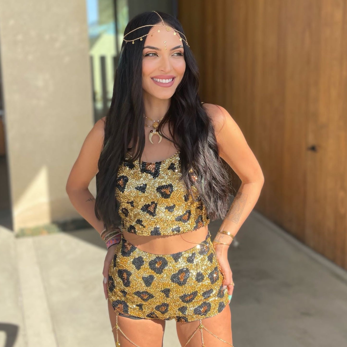festival influencer wearing gold sequin leopard print matching set to Coachella festival, festival hairstyle, burning man fashion, gold accessories, leopard print outfit.