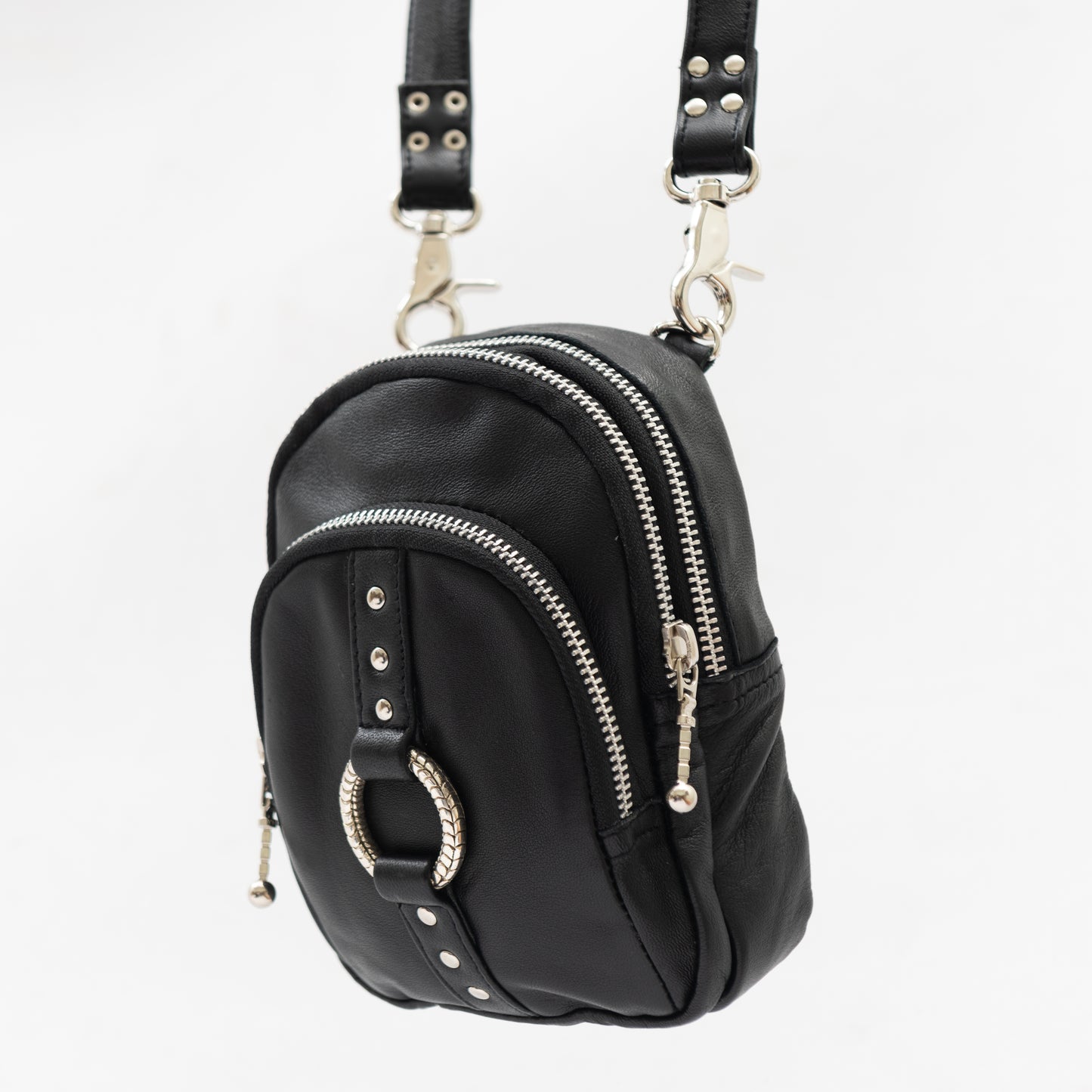 black leather and silver accessory cross body bag with removable shoulder strap and wrist strap, perfect for travel and festivals