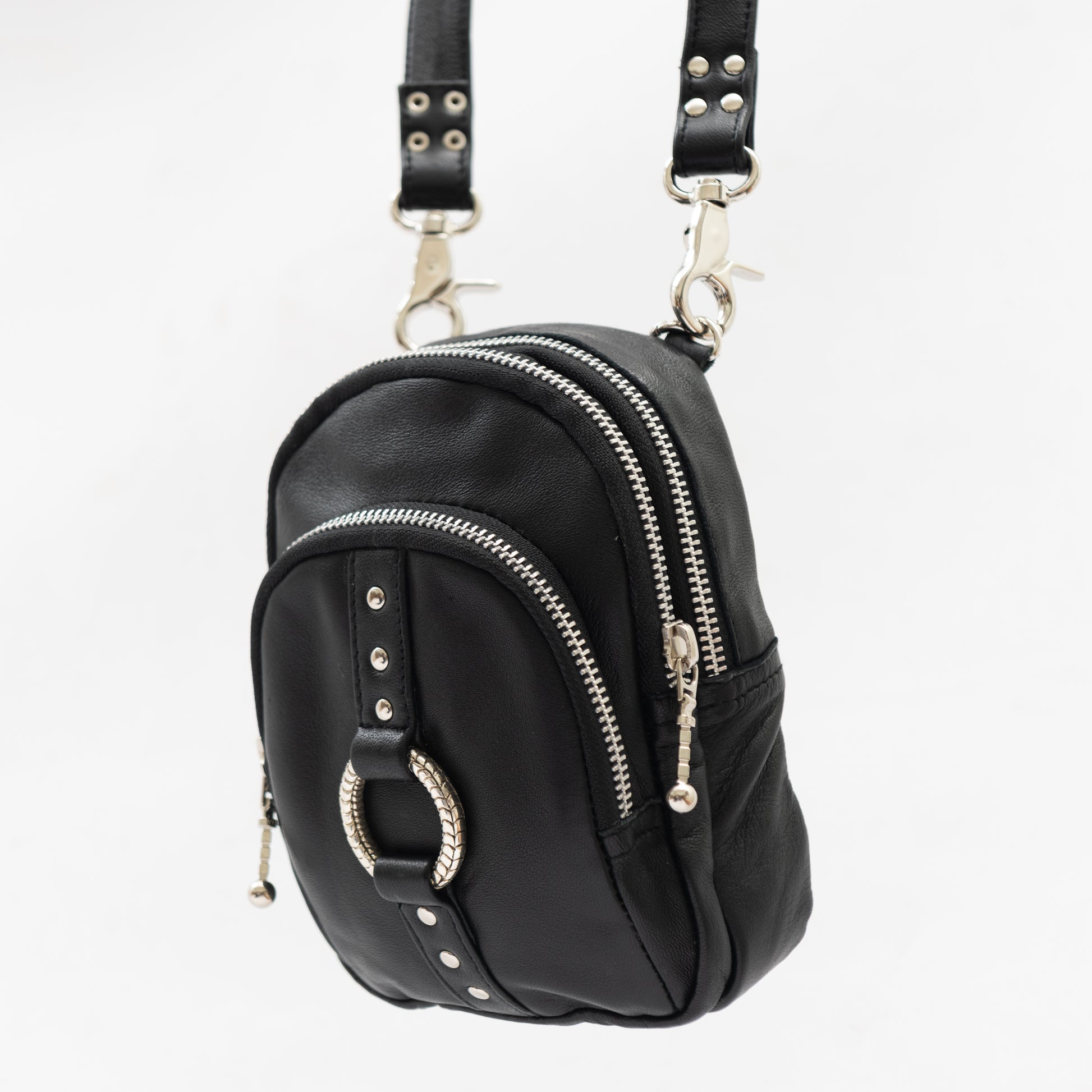 black leather and silver accessory cross body bag with removable shoulder strap and wrist strap, perfect for travel and festivals