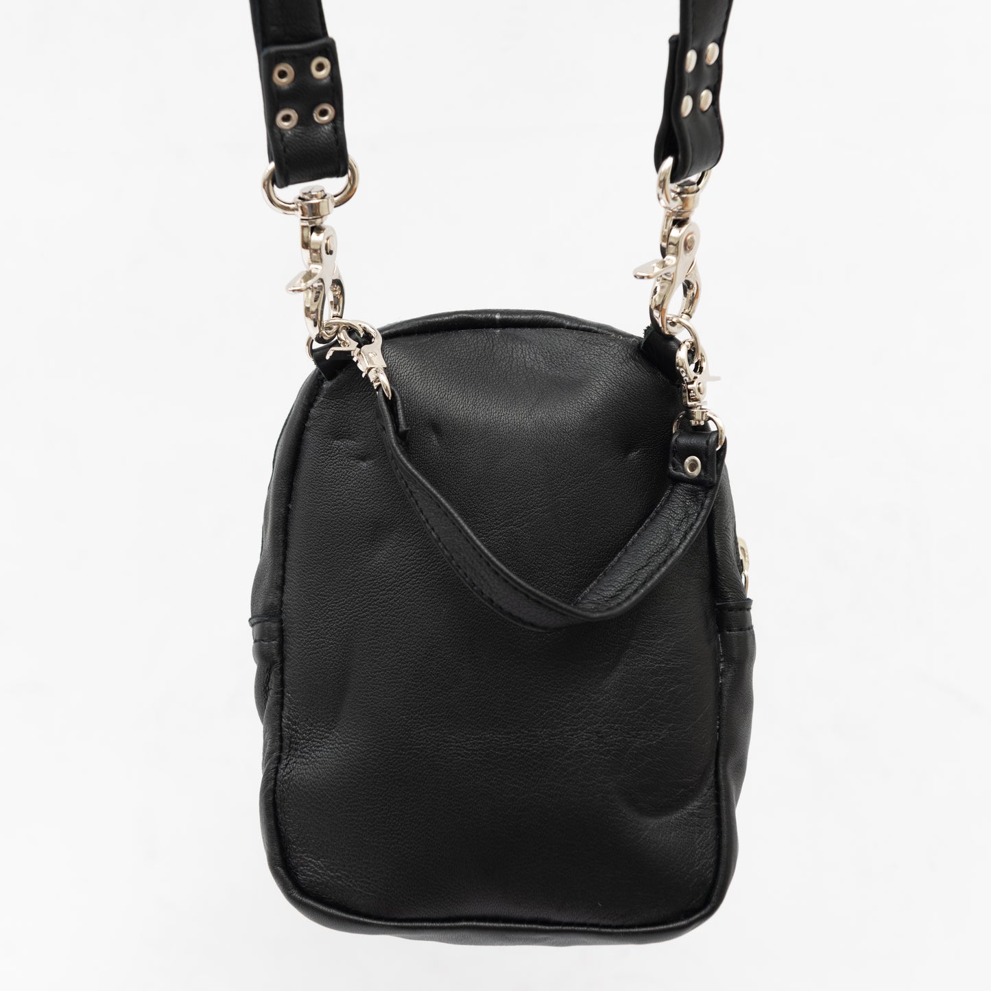 back of black leather cross body bag with removable shoulder and wrist straps