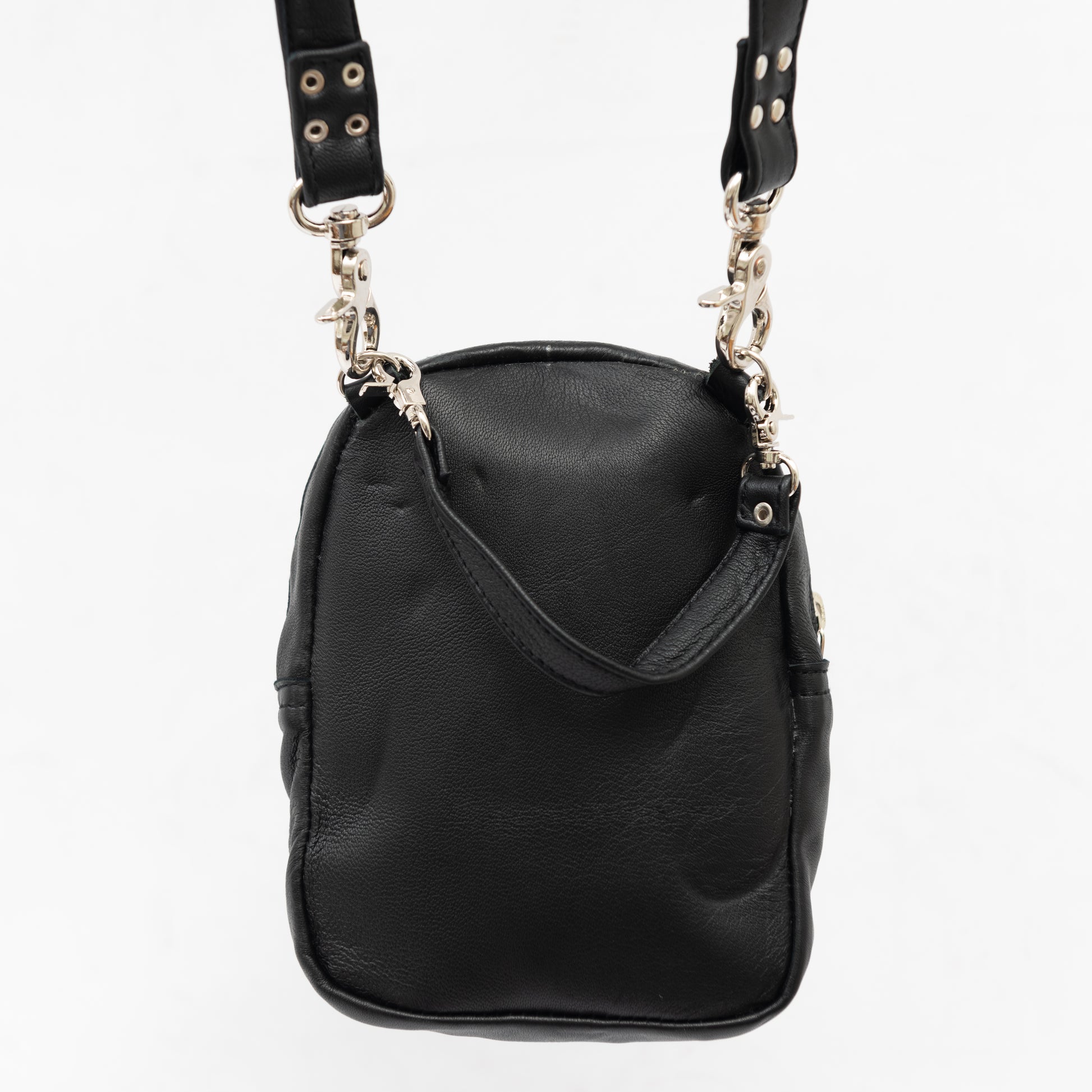 back of black leather cross body bag with removable shoulder and wrist straps