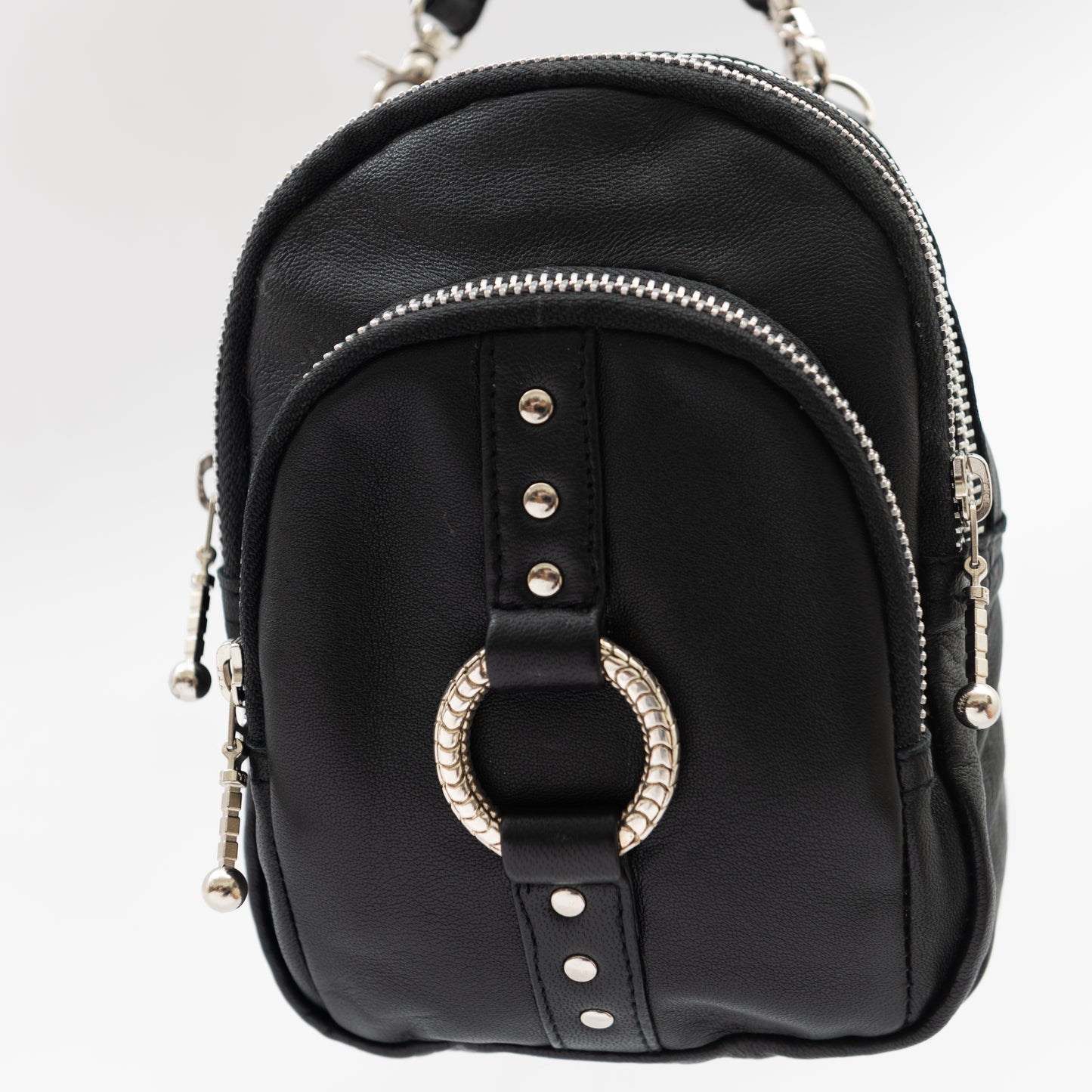 cross body bag travel bag made from soft black leather, with wrist strap for wearing on the writs as well as shoulder strap