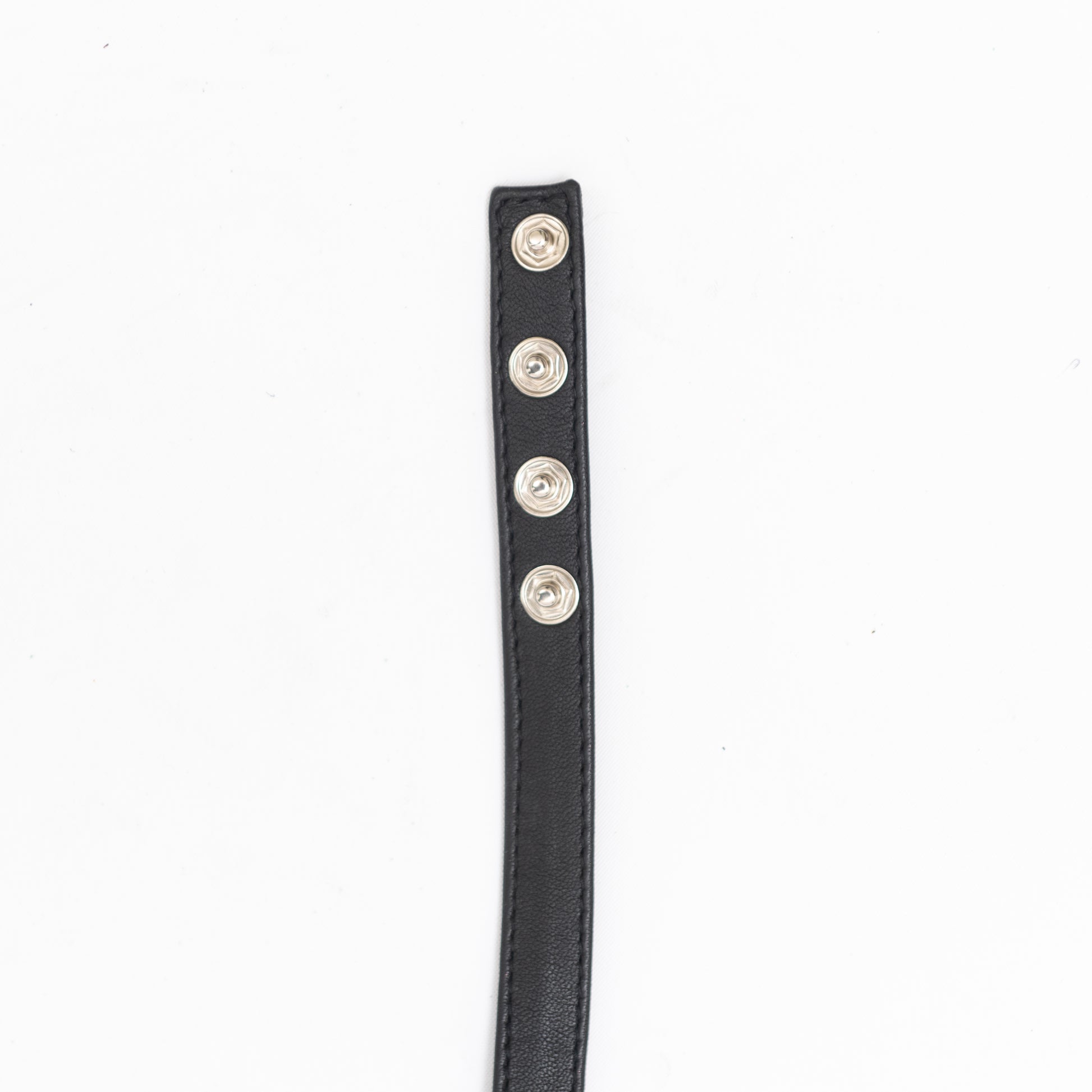 close up of end of our black leather handmade choker with button closure.