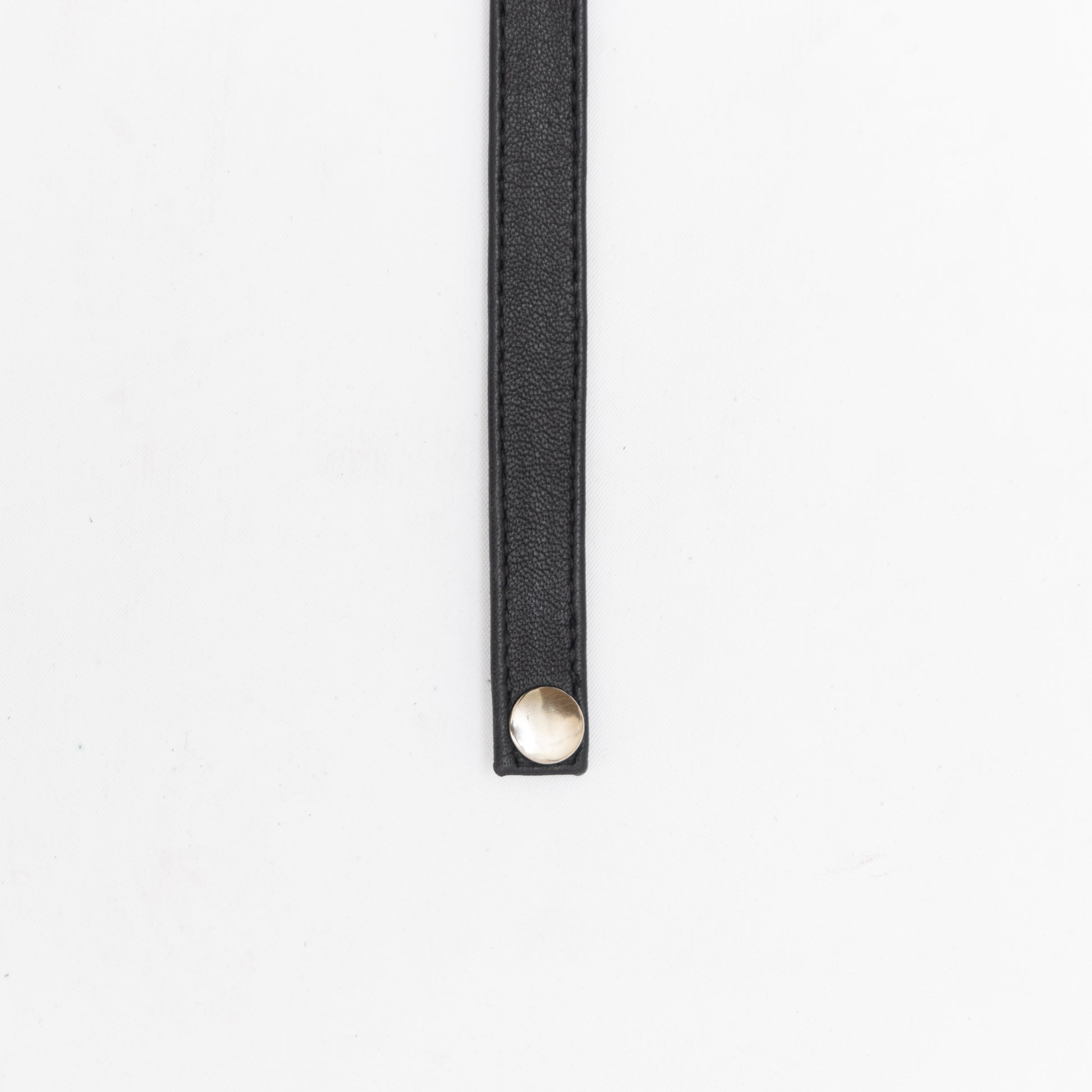 hand made leather choker with silver hardware and button closure.