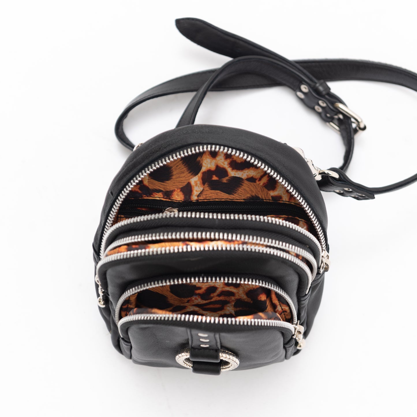 black leather cross body bag with silver hardware and leopard print lining. perfect for using as a travel bag or for your festival outfit.