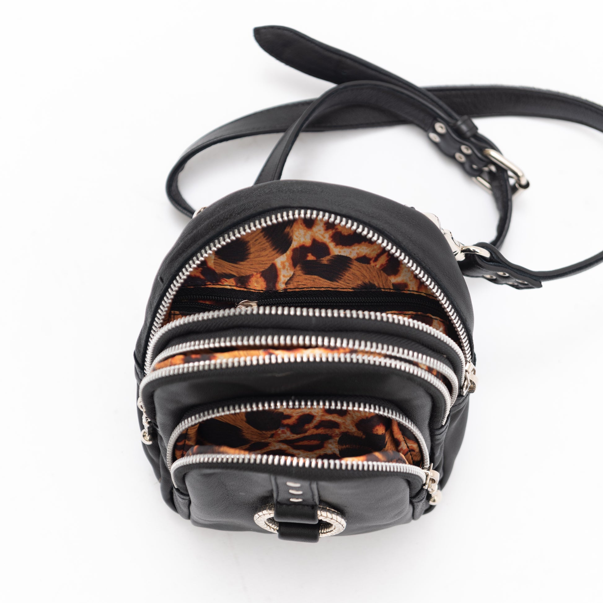 black leather cross body bag with silver hardware and leopard print lining. perfect for using as a travel bag or for your festival outfit.