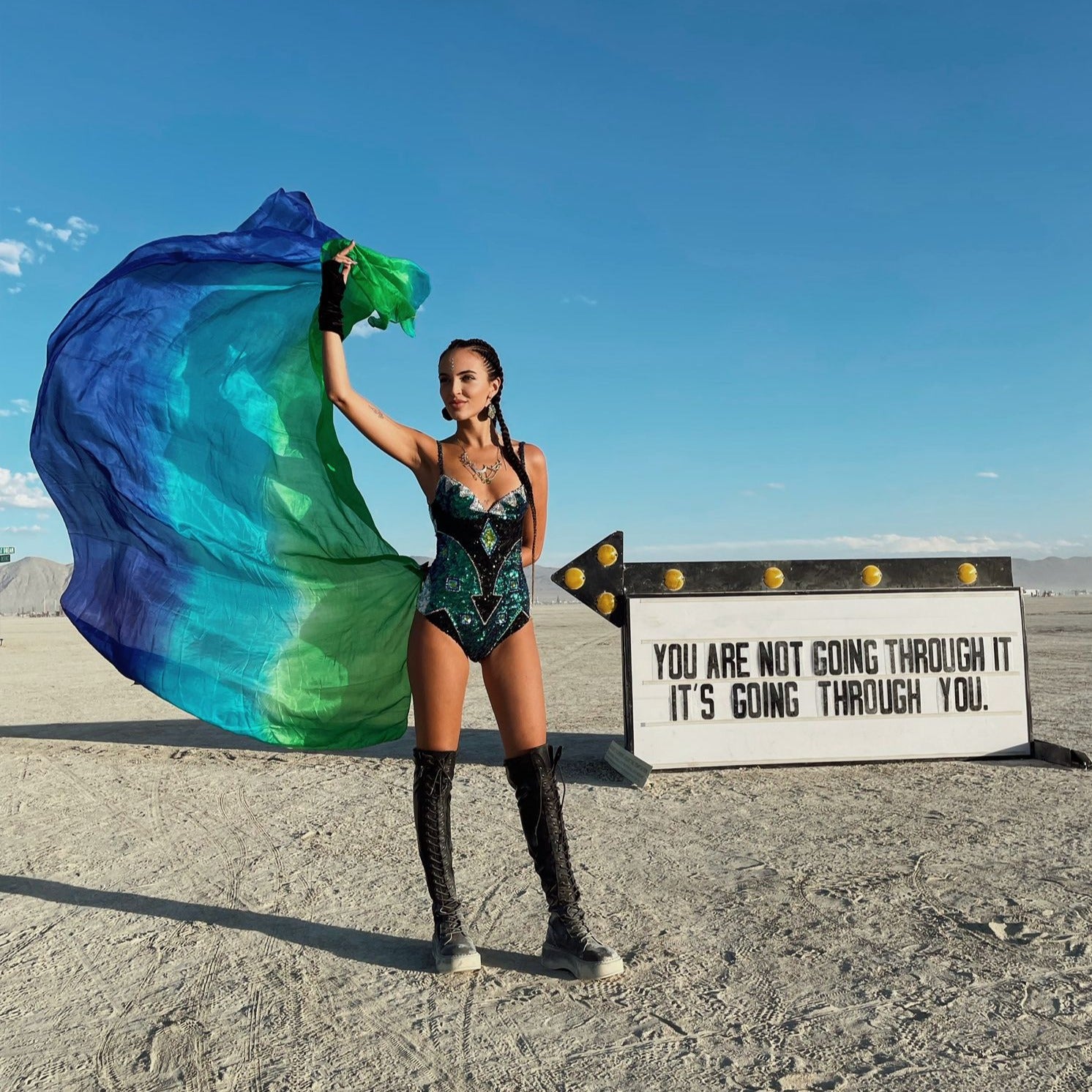Sequin bodysuit on size 8 model at burning man festival with festival boots and festival fan.