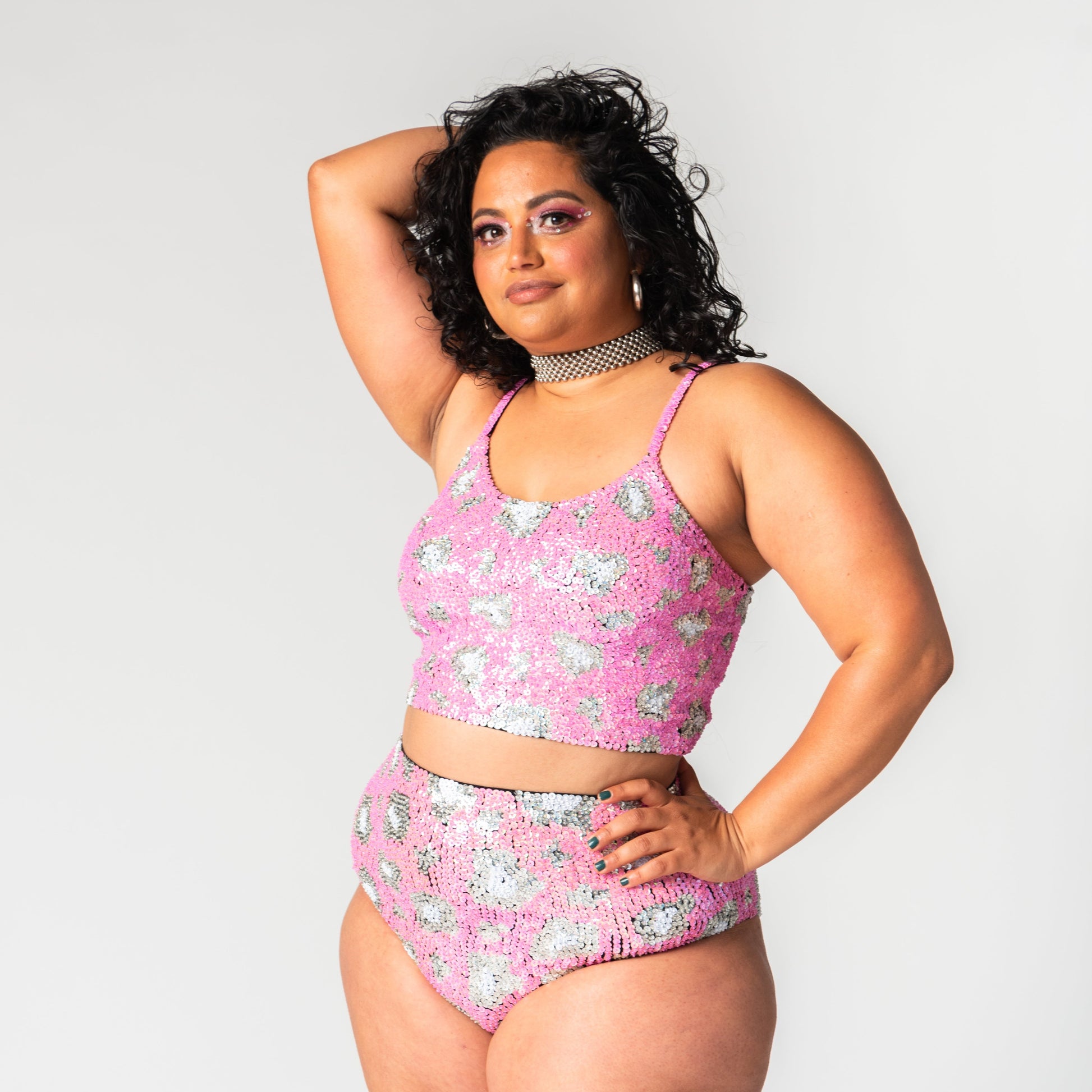 high waist sequin festival hot pants in our pink leopard print design, worn with matching sequin crop top for festival outfits.