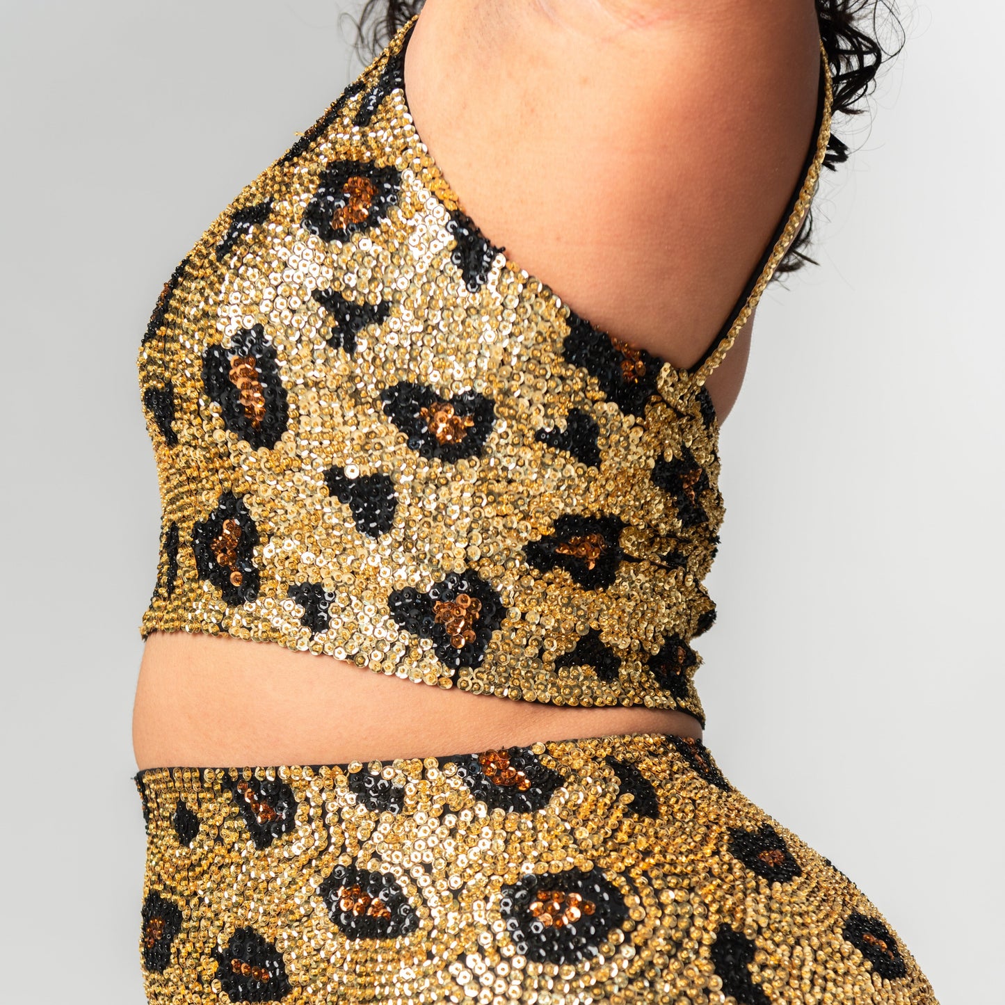 festival clothing website with matching sequin sets including this gold leopard print design crop top and hot pants.
