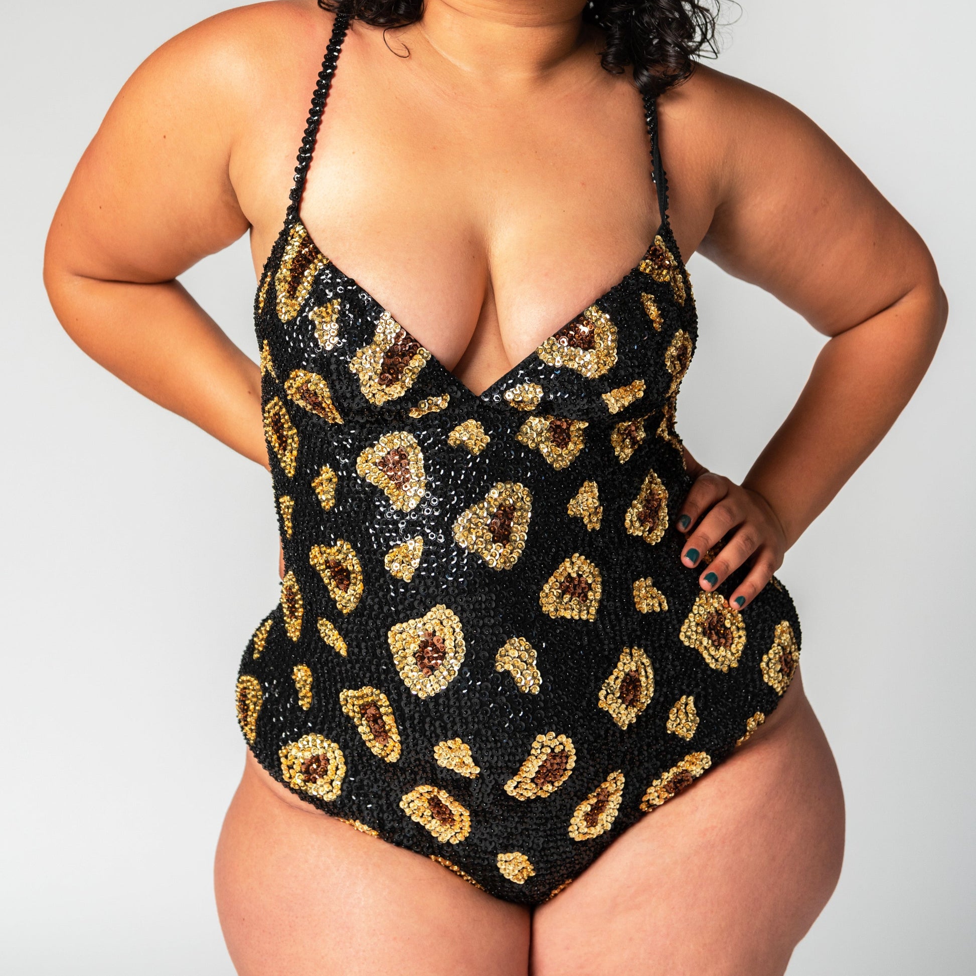 Close up of handmade sequin bodysuit in black leopard print design.