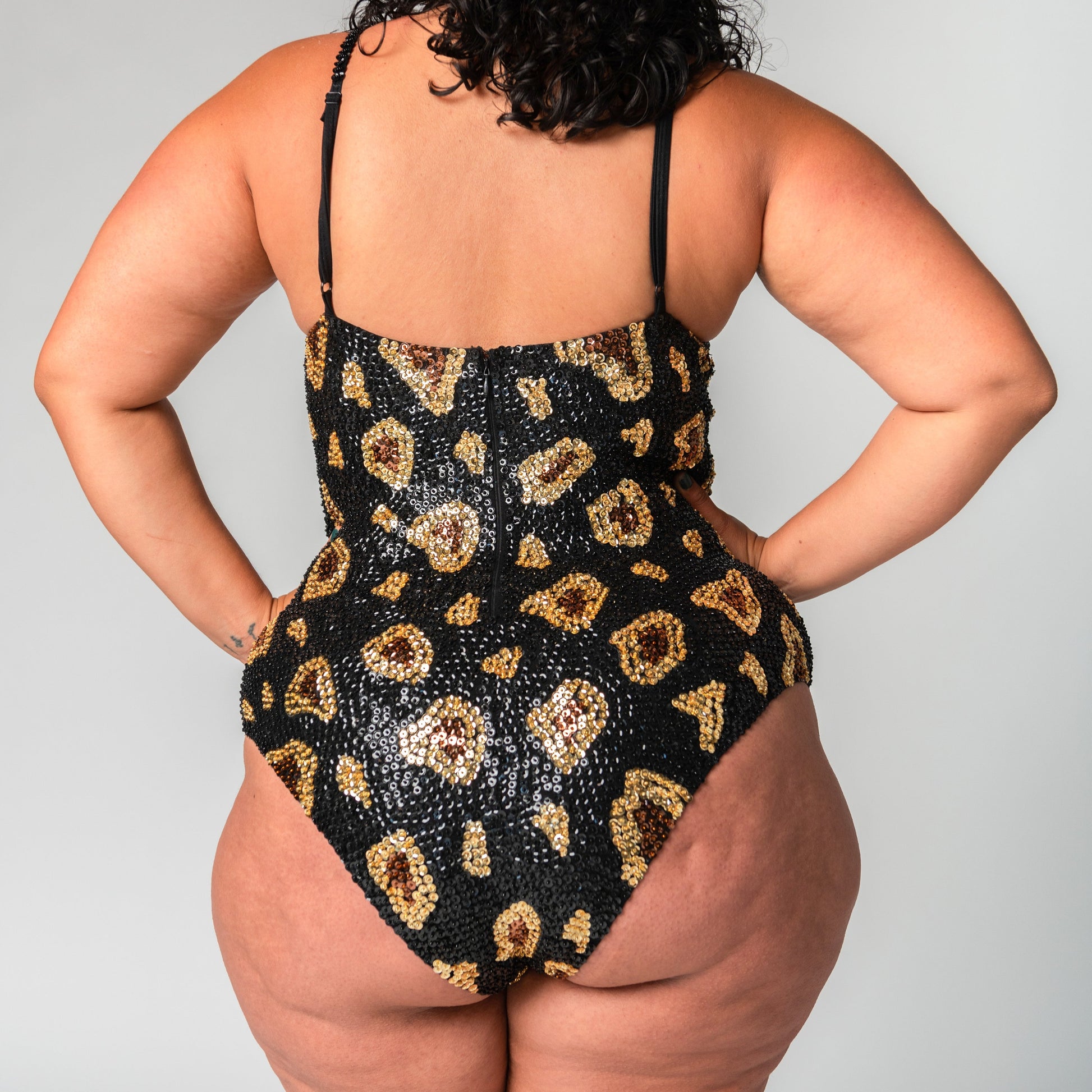 Back view of sequin bodysuit black leopard print design for festival one piece outfits.