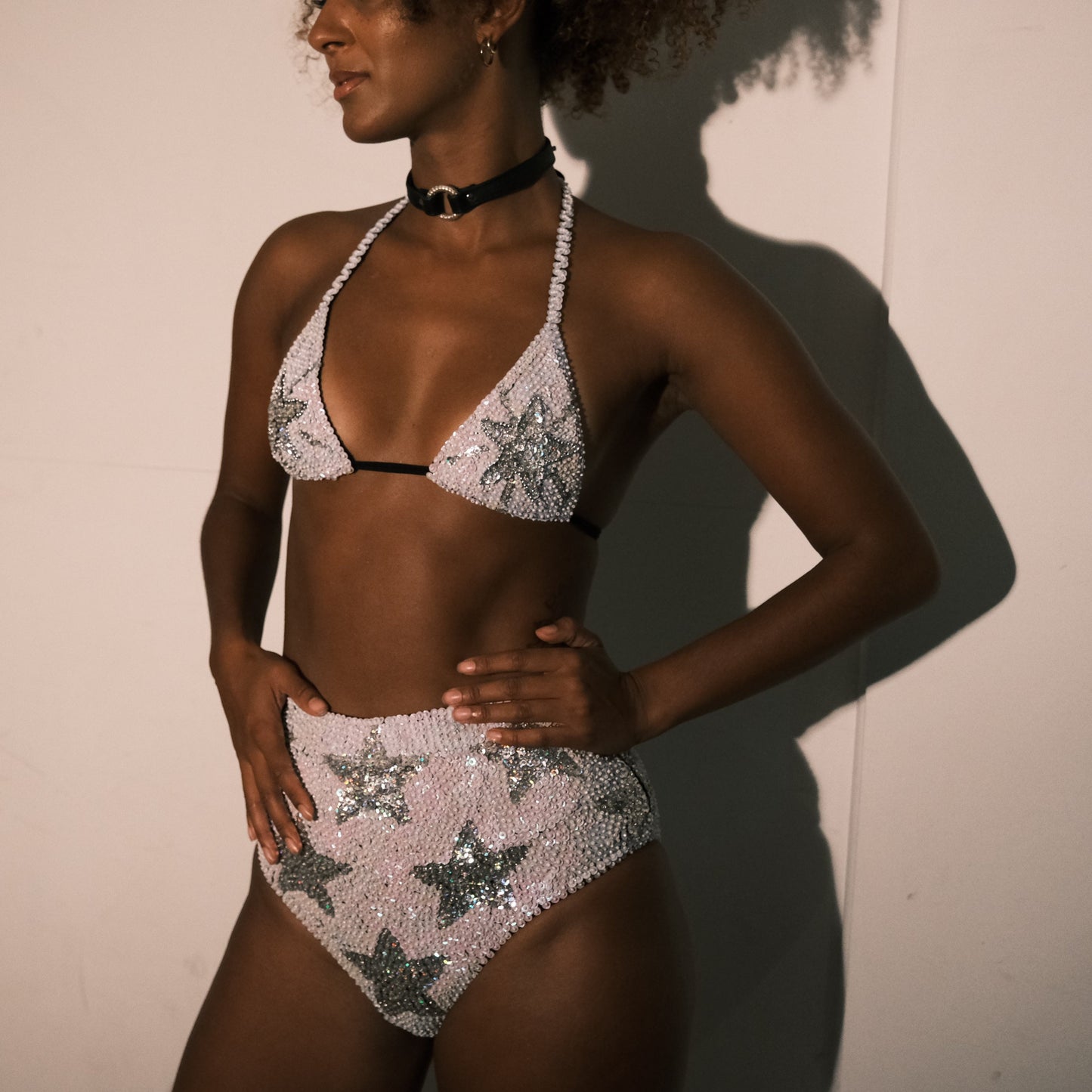 White and silver sequin high waist festival shorts with star design, handmade for festival fashion. Ideal for bridal party outfits, hen do outfits, hen party costumes, Taylor Swift concerts, and Henchella theme bachelorette celebrations. Chic, sparkly hens hot pants and eye-catching.