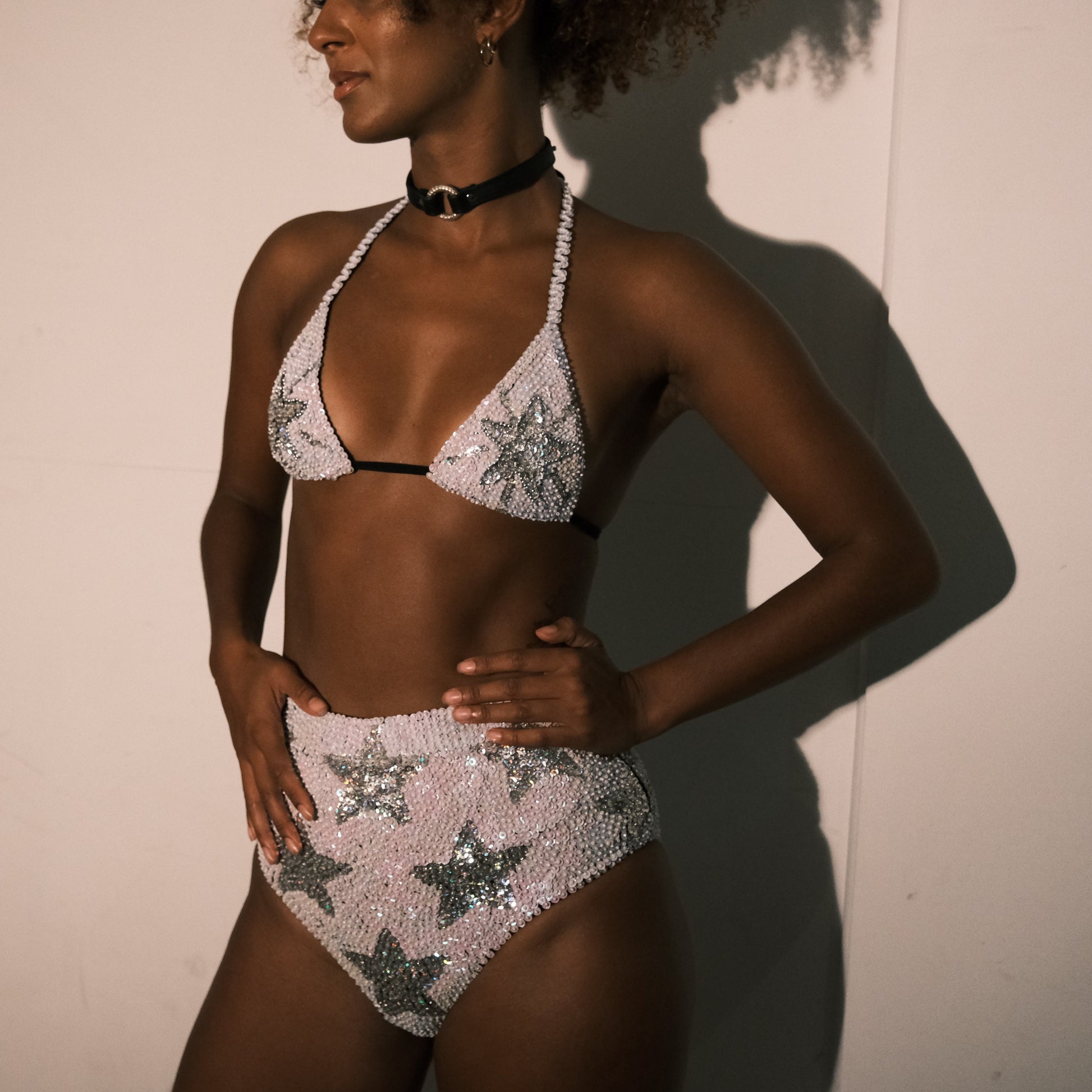 White and silver sequin high waist festival shorts with star design, handmade for festival fashion. Ideal for bridal party outfits, hen do outfits, hen party costumes, Taylor Swift concerts, and Henchella theme bachelorette celebrations. Chic, sparkly hens hot pants and eye-catching.