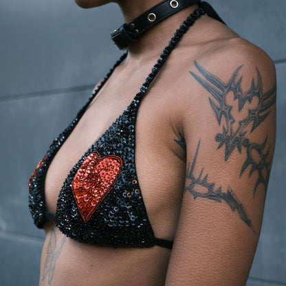 Black and red sequin crop top with heart designs on the breasts, handmade for festival outfits. Pairs with matching hot pants for a complete look at EDC, Bonnaroo and Burning festival.