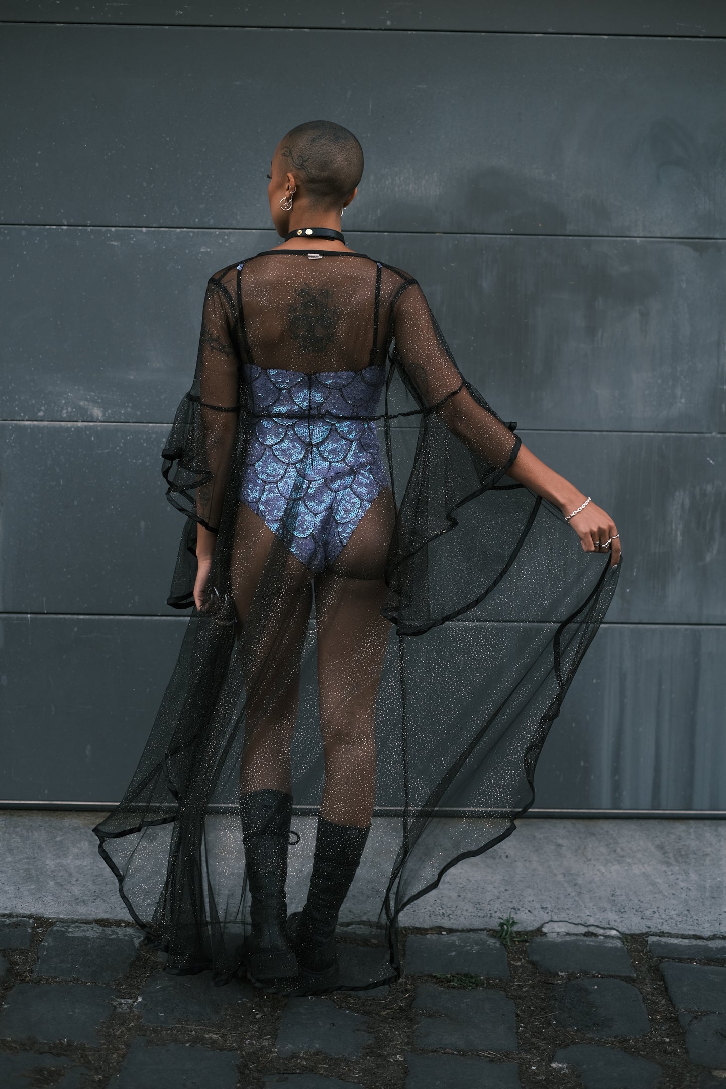 Black mesh kimono with gold sparkles, perfect for festival outfits. Soft, comfortable, and bouncy with a sexy design. Ideal as a chic duster for standout festival fashion.