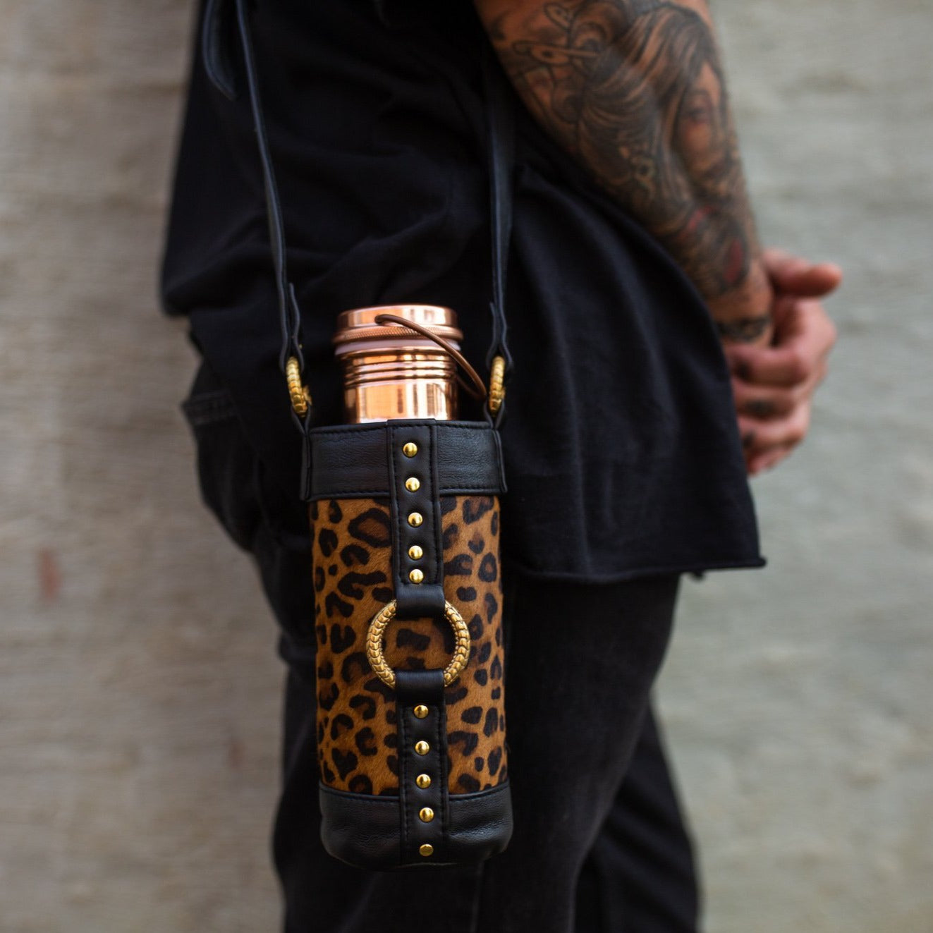 water bottle holder bag for walking and burning man festival, made from genuine leather with Leopard print design and high quality gold hardware