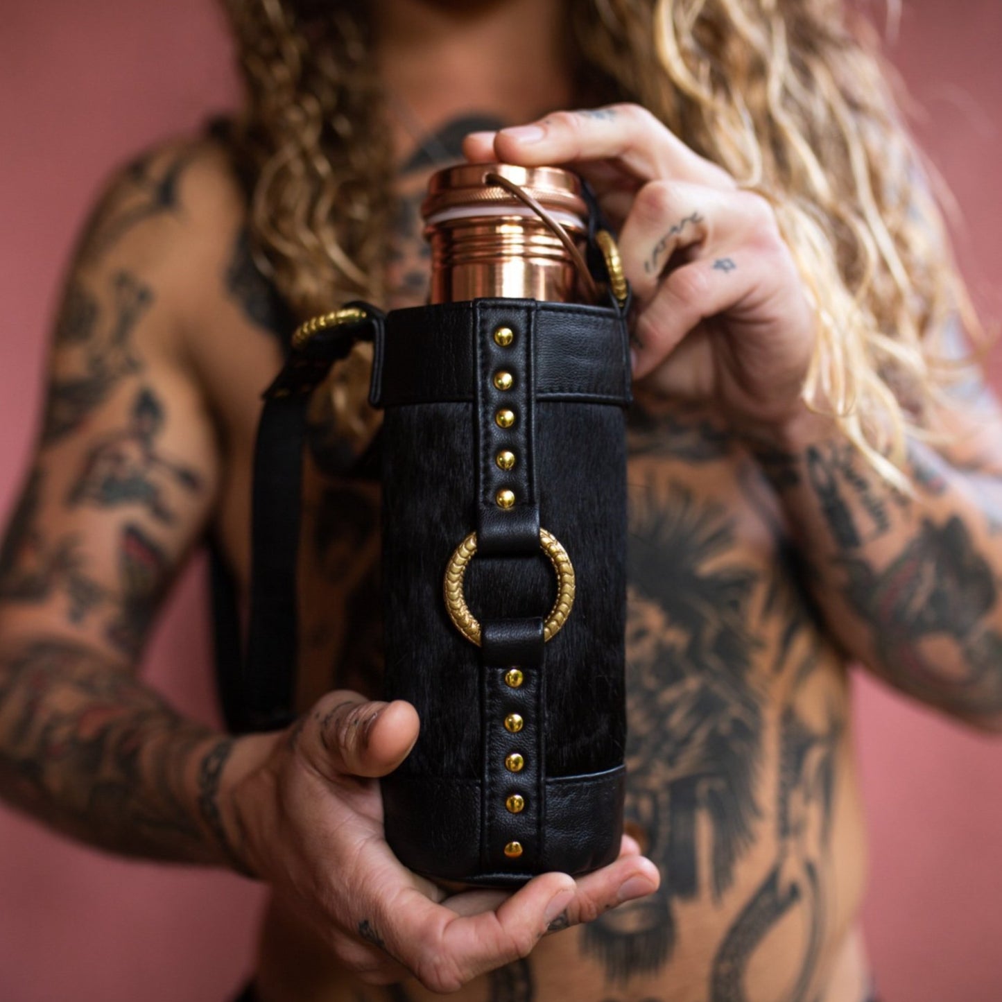 Reusable Water Bottle Bag with strap made from black leather and gold hardware, perfect for burning man festival 