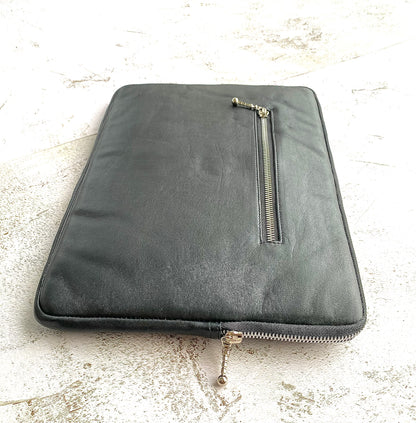 genuine black leather laptop bag with zip pocket and zip closure. 