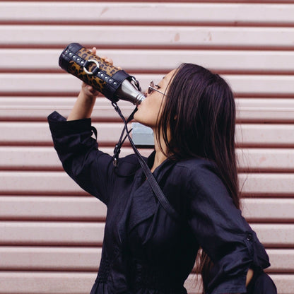 crossbody water bottle holster bag made from leather with leopard print design and adjustable shoulder strap