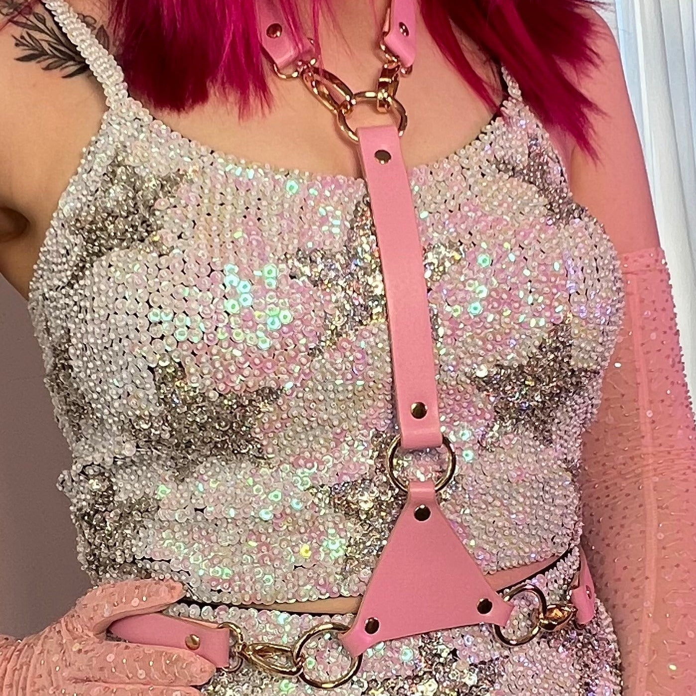 pearl white sequin and holographic silver star festival crop top worn with pink harness and gloves for festival outfit.