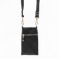 back of black leather phone bag with silver hardware and hidden zip.