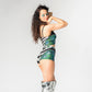 Side and back view of hand made green, black and silver matching sequin high waist hot pants and crop top for festival outfit. 