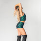 side view of matching mermaid set of crop top and high waist hot pants with green sequins for mermaid costume or rave outfit. 