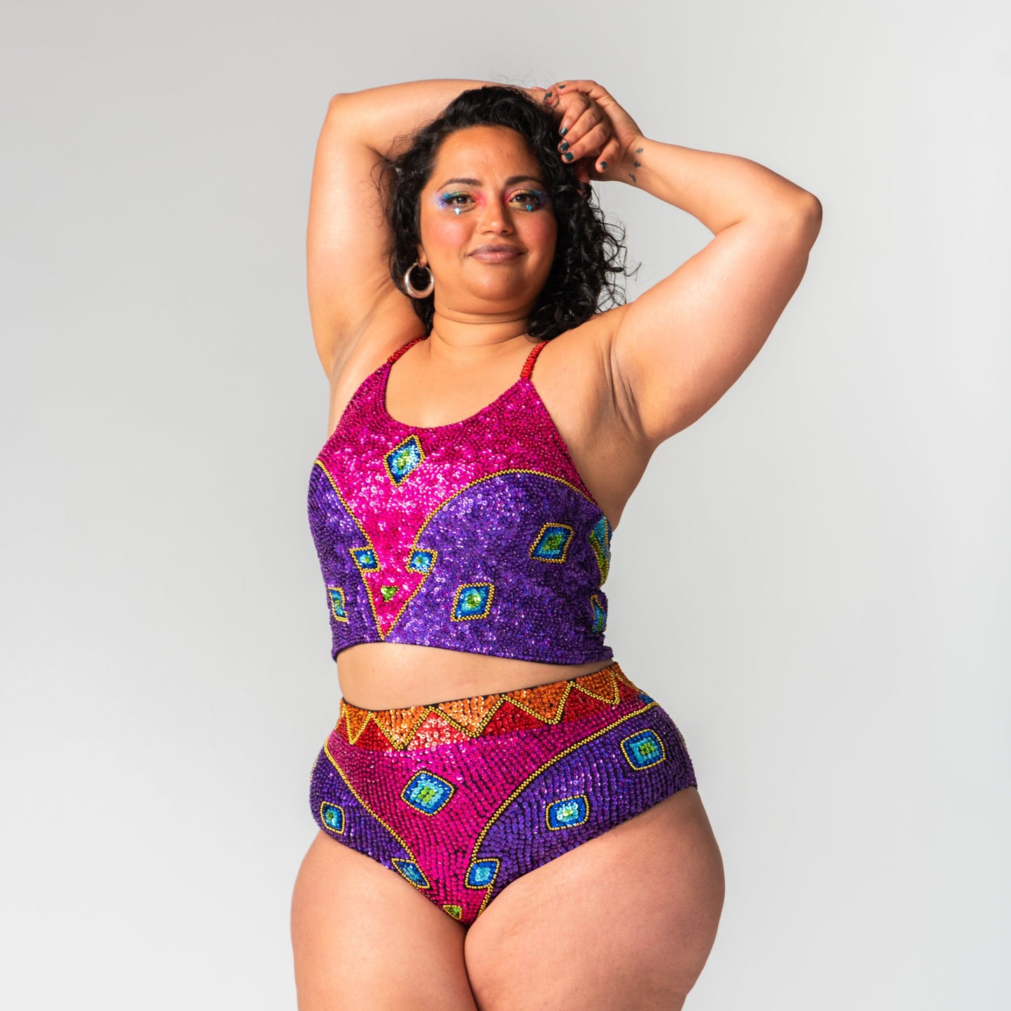 Matching festival two piece set in our rainbow design with every colour sequin of the rainbow. Worn on plus size model. 