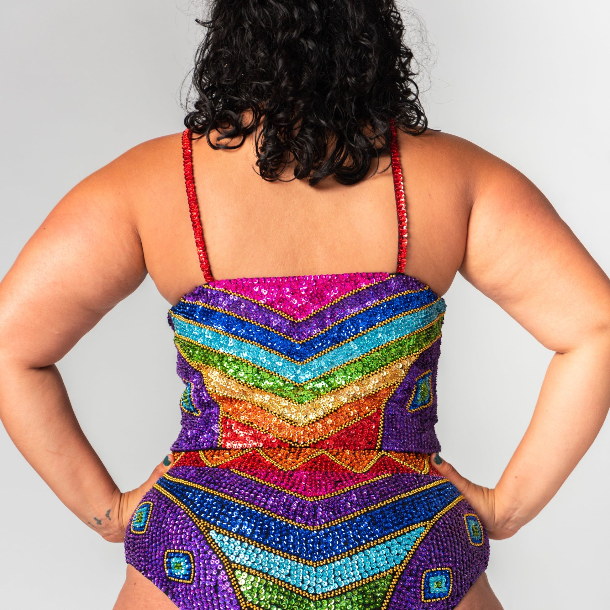 hand made sequin festival crop top with rainbow design on the back, with matching festival bottoms.