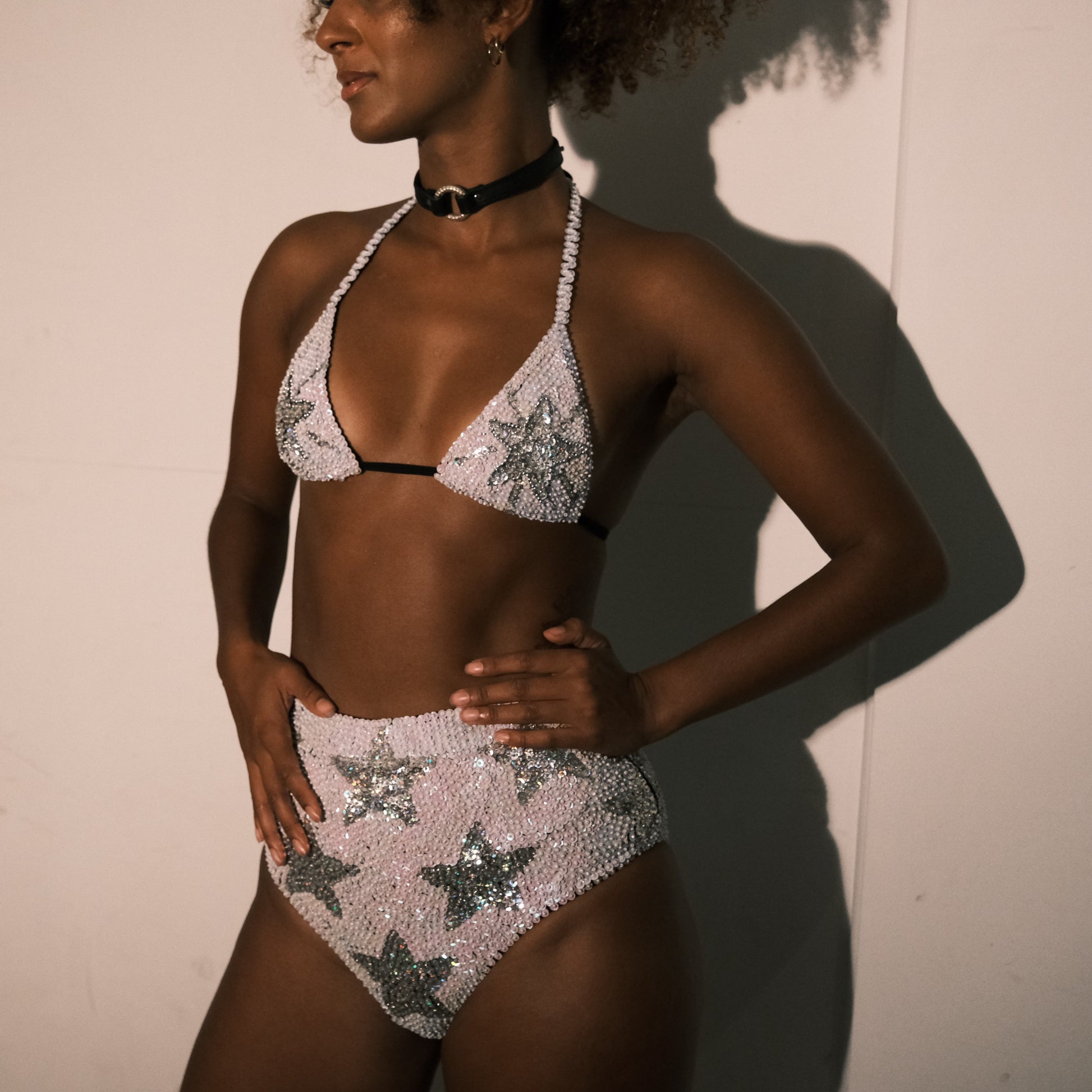 White and silver sequin bikini top with star design, handmade for hen party outfits. Ideal for adding a stylish touch to bridal party looks, festival fashion, and Henchella. Sparkly and eye-catching.