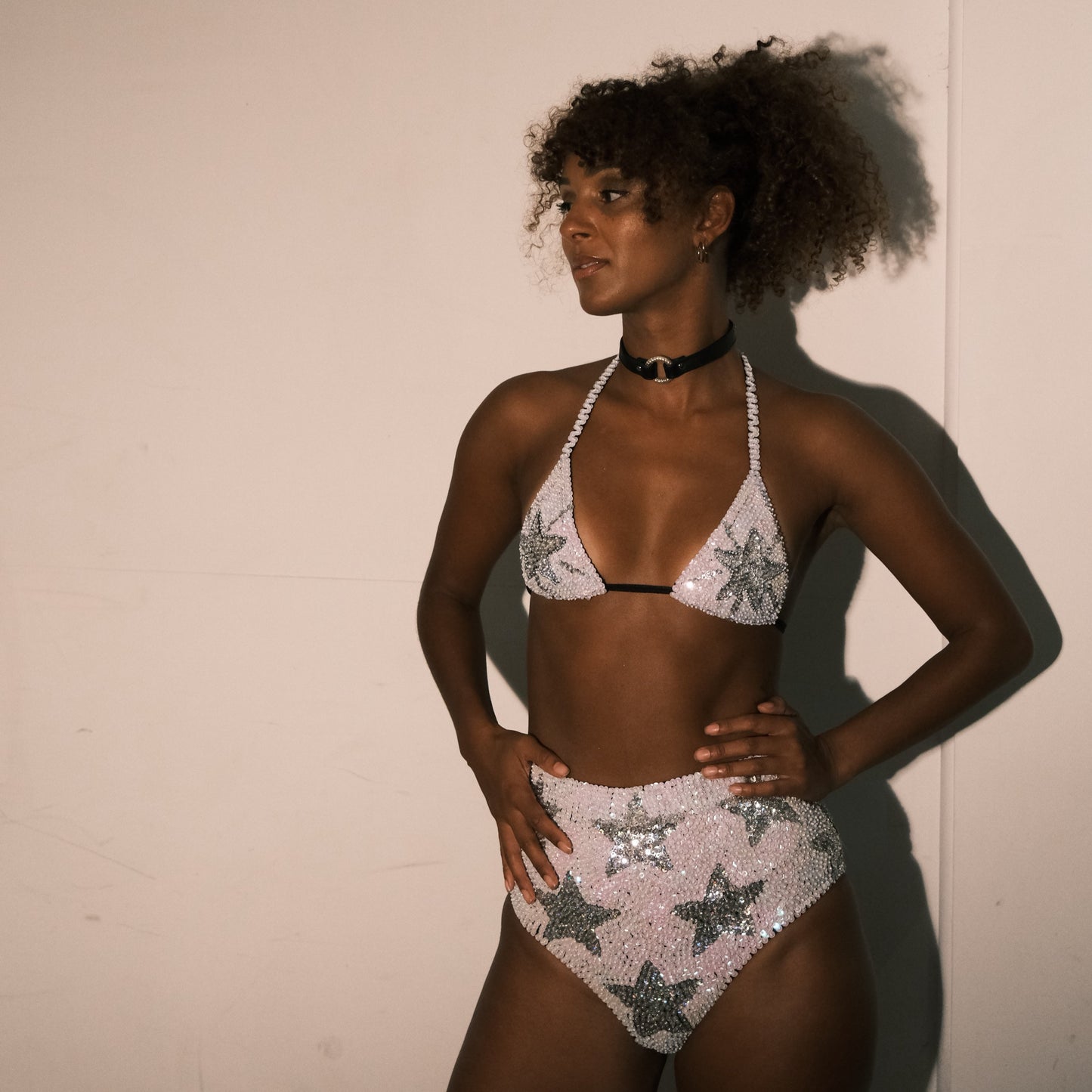 White and silver sequin bikini top with star design, handmade for making a statement at Taylor Swift Eras Tour. Ideal for festival outfits, bridal party looks, hen do outfits, and Henchella. Stylish and comfortable.